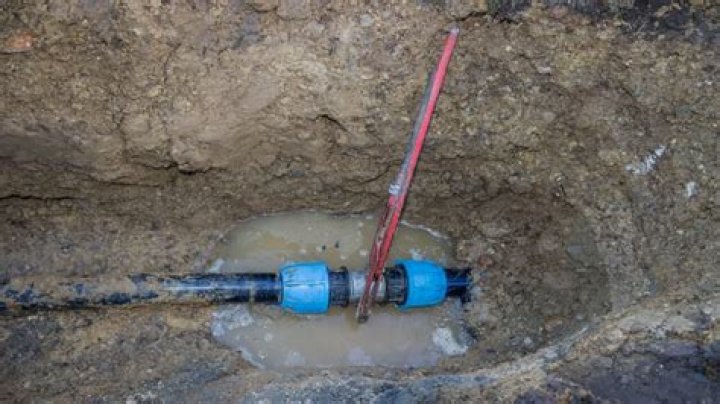 Natural gas line leak beneath river interrupts service